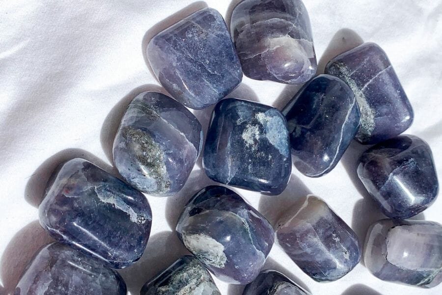 A group of polished deep purple to blue Iolite crystals
