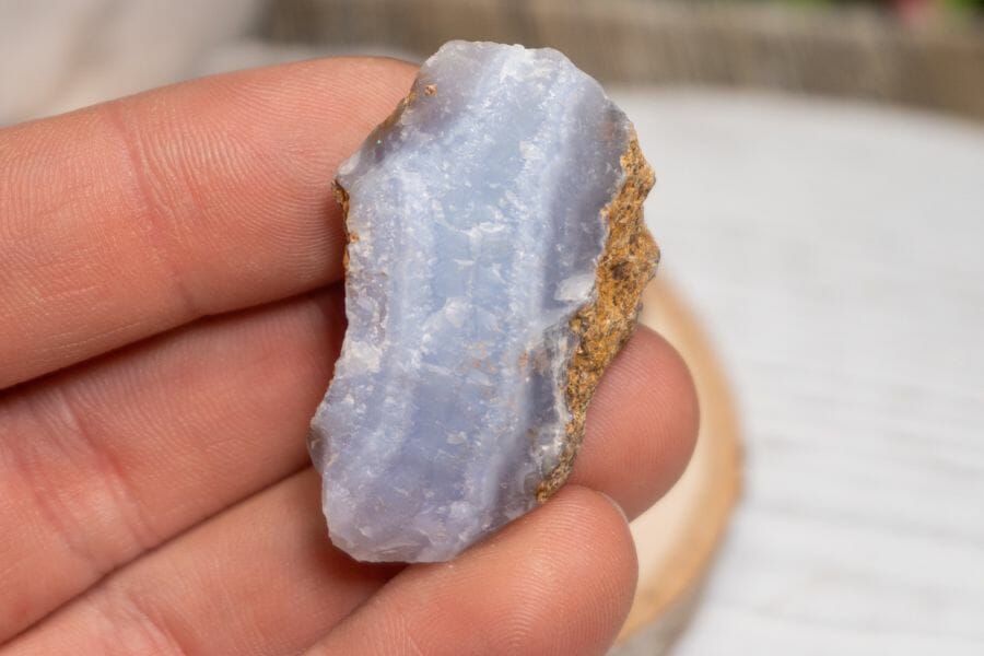 A pretty little chalcedony resting on someone's fingers