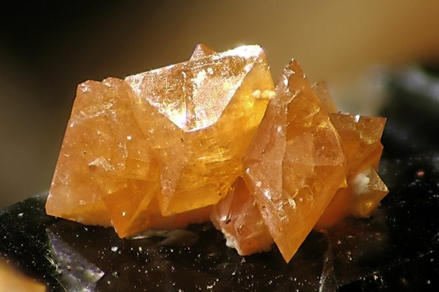 A stunning citrine with a unique shape on top of a black surface