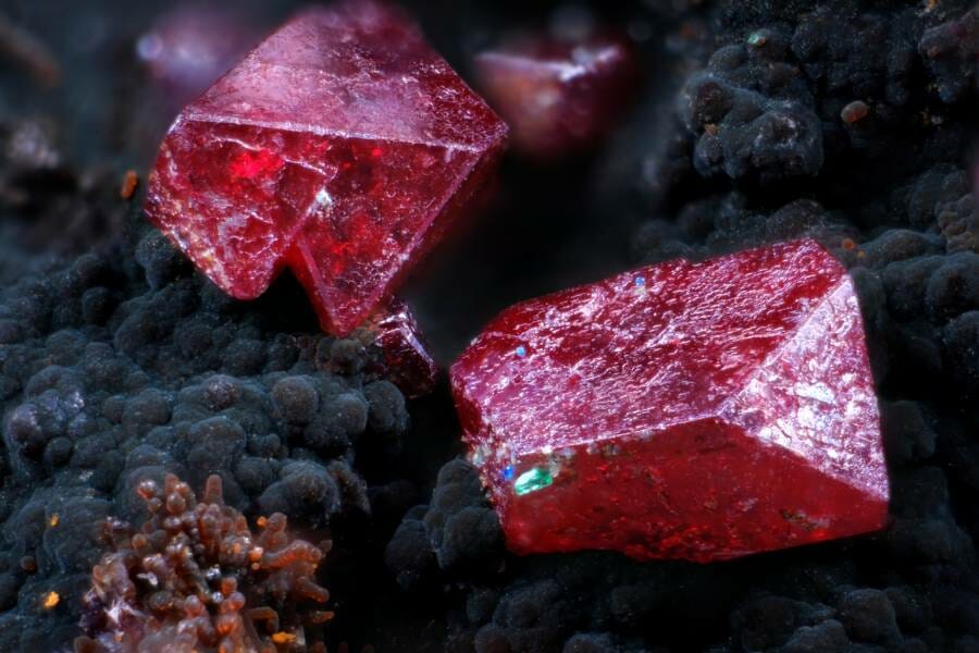 Red crystals on a black rock background