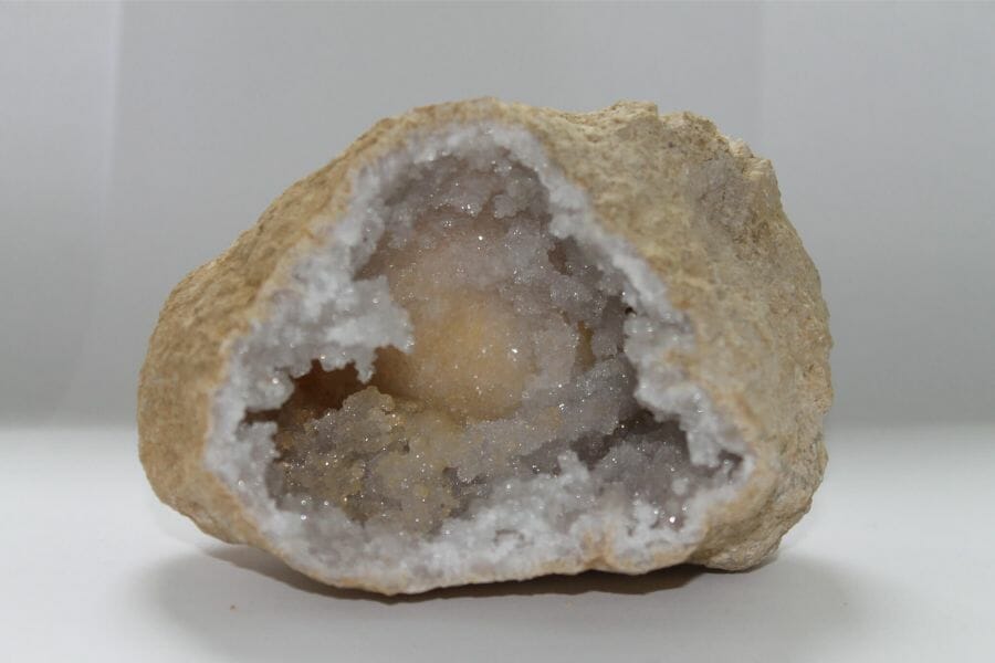 A stunning crystal geode with white and yellowish crystals inside