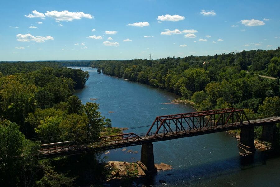 An aerial view of the Tallapoosa River and its surrounding forests and bridge
