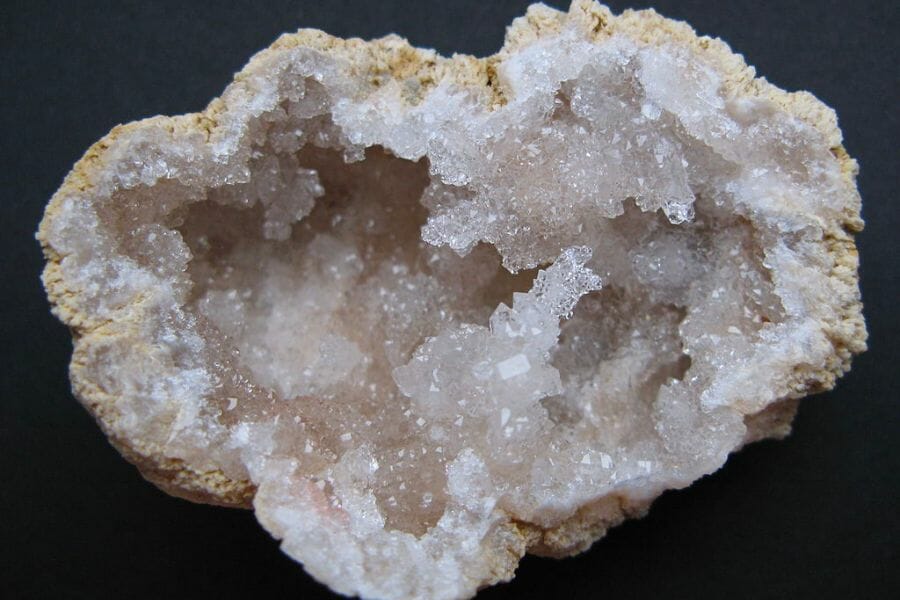 An open geode showing its white crystal interior
