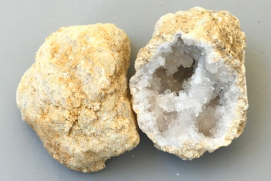 Two sides of an open geode with with crystals