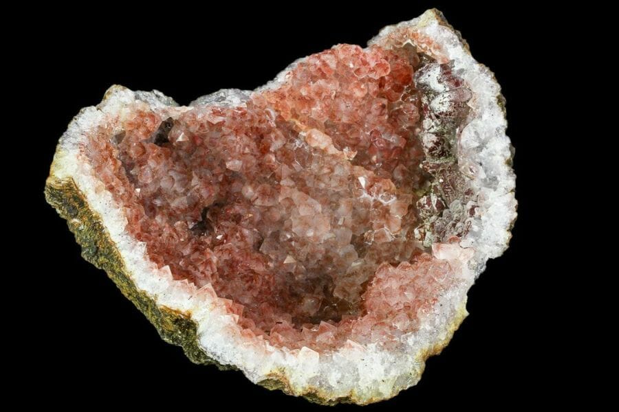 A stunning pink hematite geode with brown crystals