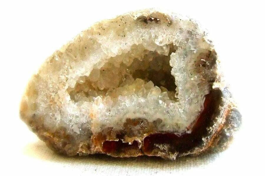 A classic sample of a cracked open geode with white crystals