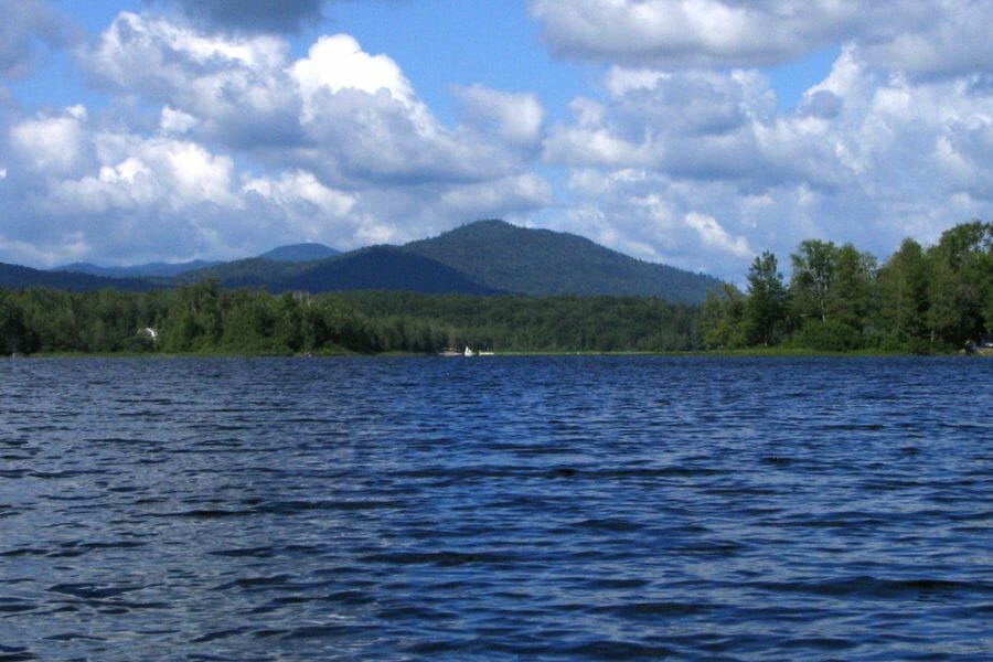 A scenic view of the lake, trees, and mountain at Lake Harris
