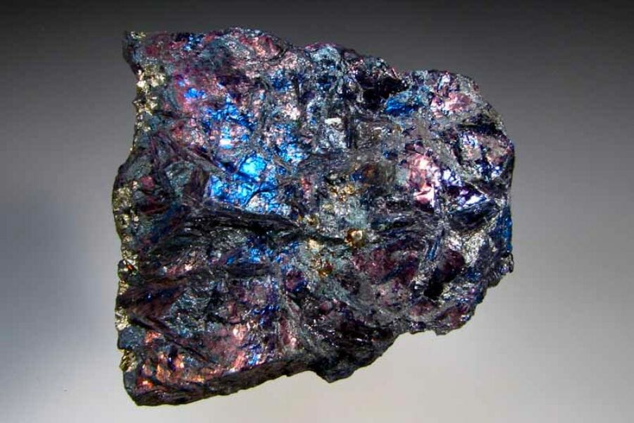 A black Covellite crystals with metallic blue and purple reflections