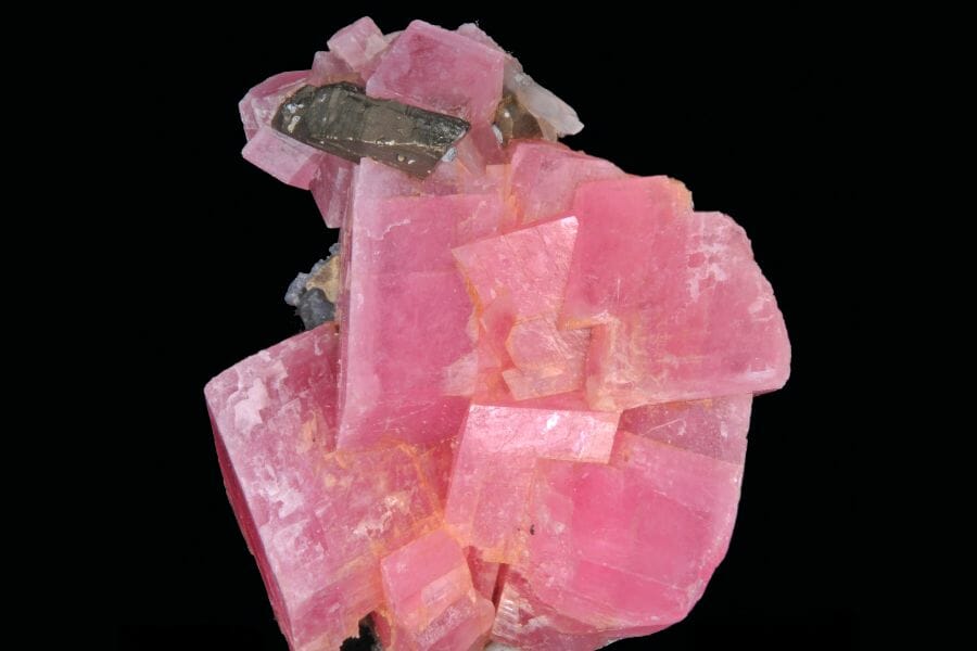 Pink Rhodochrosite crystals with translucent black Chalcopyrite
