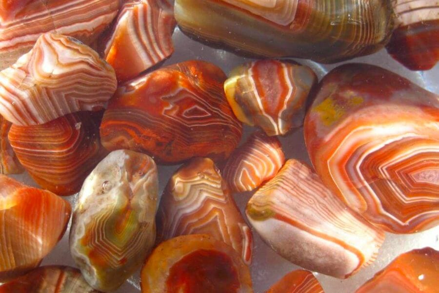 A bunch of orange Lake Superior Agates with interesting patterns