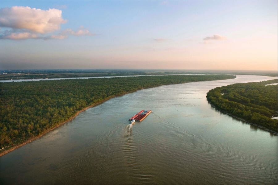 A wide view of the Mississippi River with a boat passing by