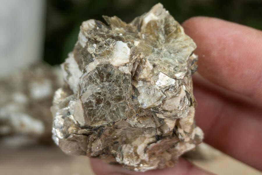 A tiny pretty muscovite with brown hues and white minerals