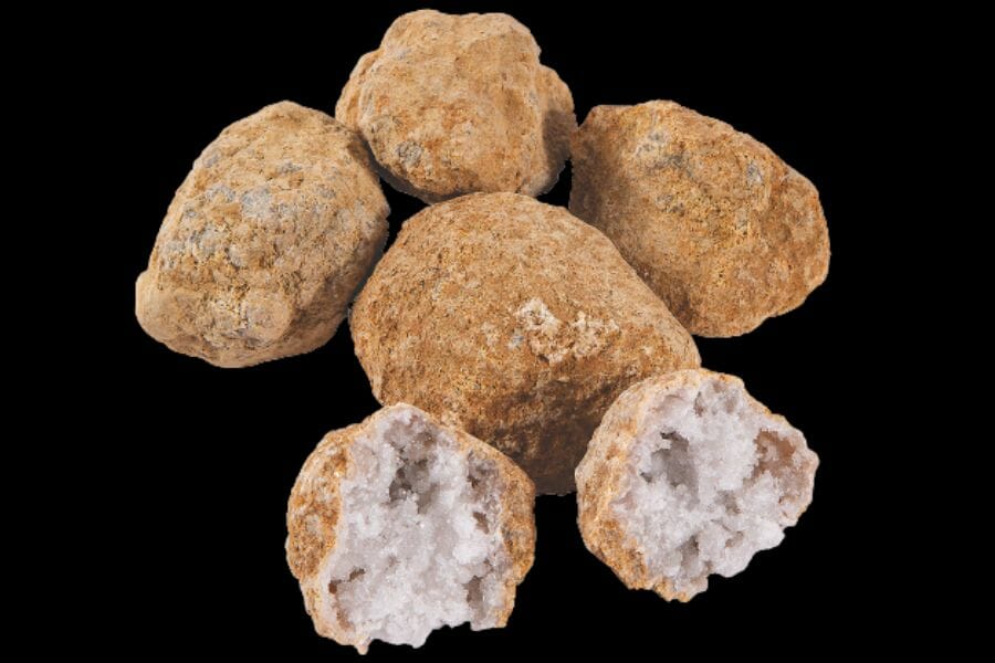 Five samples of geodes, with one that is cracked open, revealing white crystals