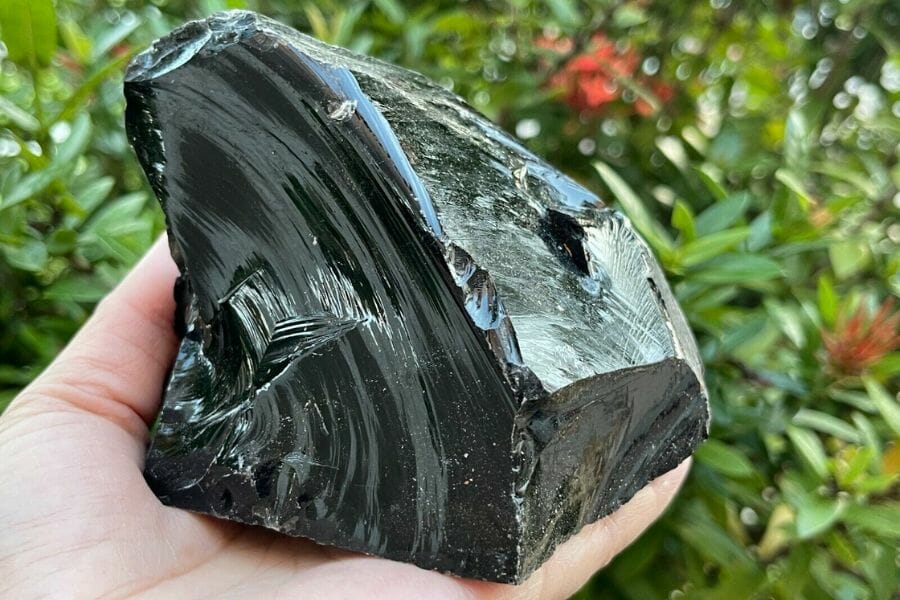 An elegant black obsidian with a unique cut and an irregular shape