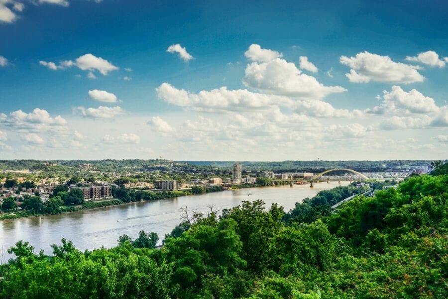 An aerial view of the Ohio River including the city and the lush green trees