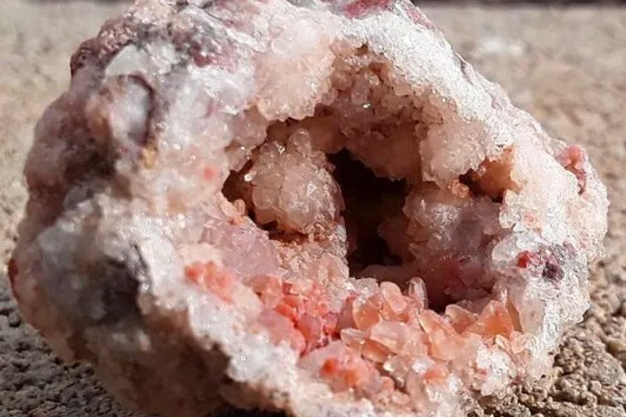 An open geode with beautiful white and pinkish crystals inside