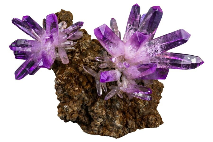 A bunch of purple Amethyst crystals atop a rock