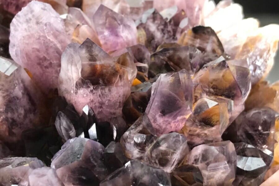 A cluster of light to dark purple Amethyst crystals