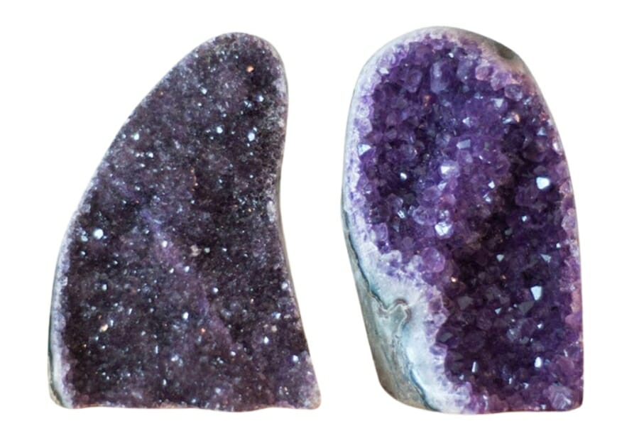 Two halves of opened Amethyst Geodes showing different intensities of the purple hue and different crystal sizes