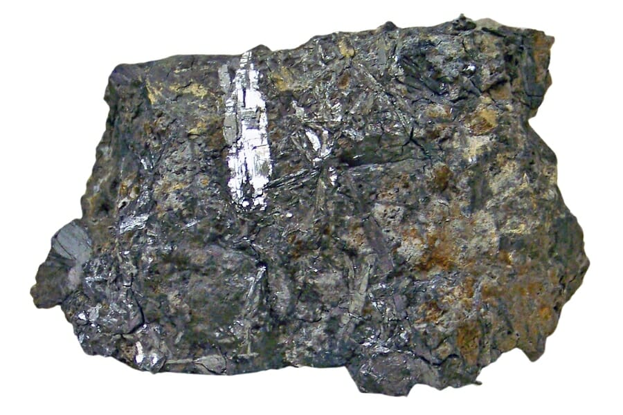 A huge piece of grayish Bismuthinite ore with hints of orange details on the side