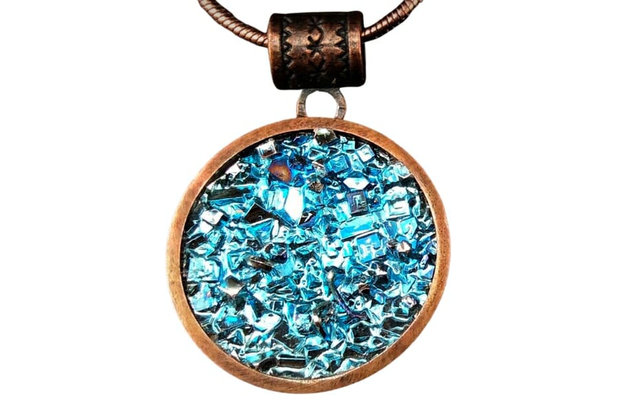 A bronze circle pendant adorned by blue Bismuth