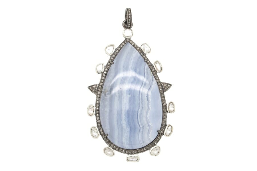 A piece of Blue Lace Agate on a silver pendant