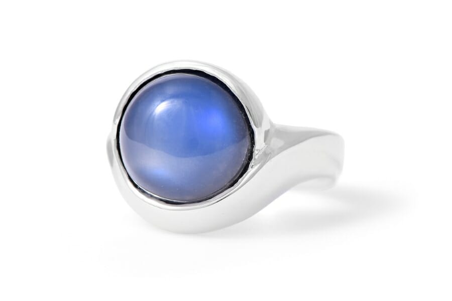 A platinum ring with a round Blue Moonstone set as center stone