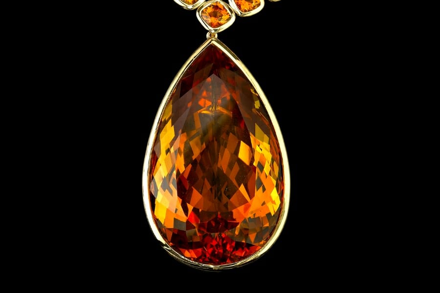 A large teardrop-shaped Madeira Citrine set as pendant on necklace