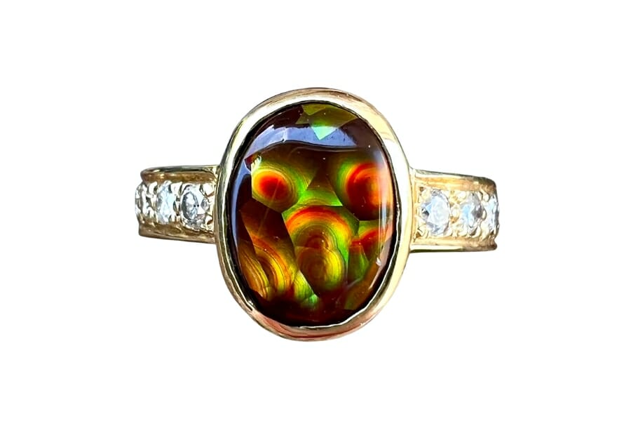 A gold ring with small white diamonds and a Fire Agate as center stone