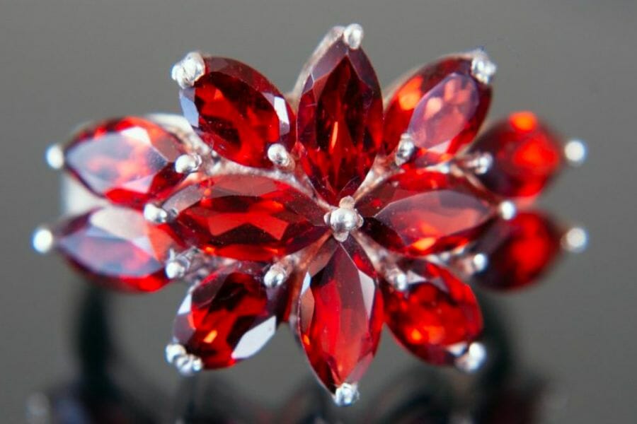 Teardrop red Garnets set in a flower-shaped center of a ring