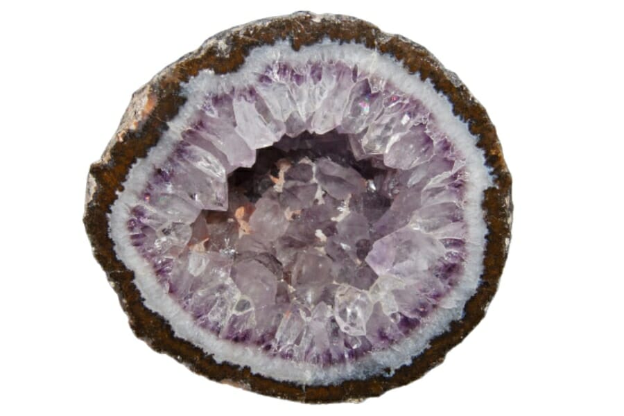 A round, open geode displaying crystals of white with purple ends