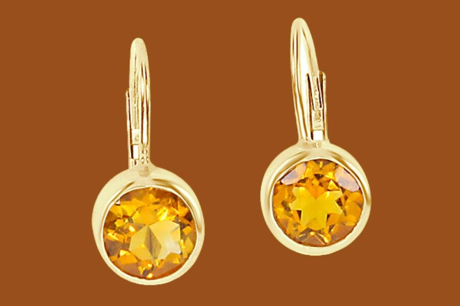 A pair of gold earrings with round Gold Citrines
