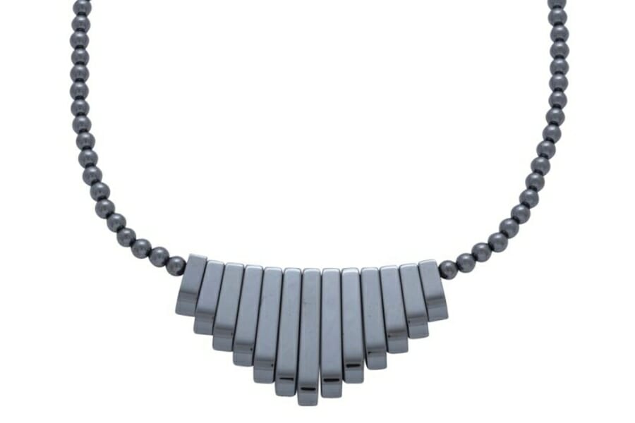 A necklace made out of gray, polished Hematite beads and bars