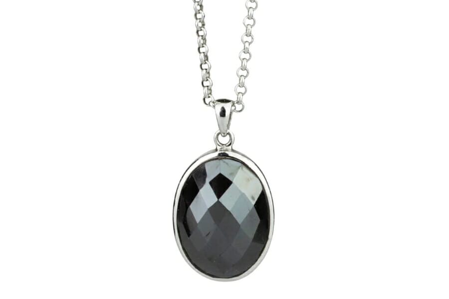 A silver pendant with a black, polished Hematite