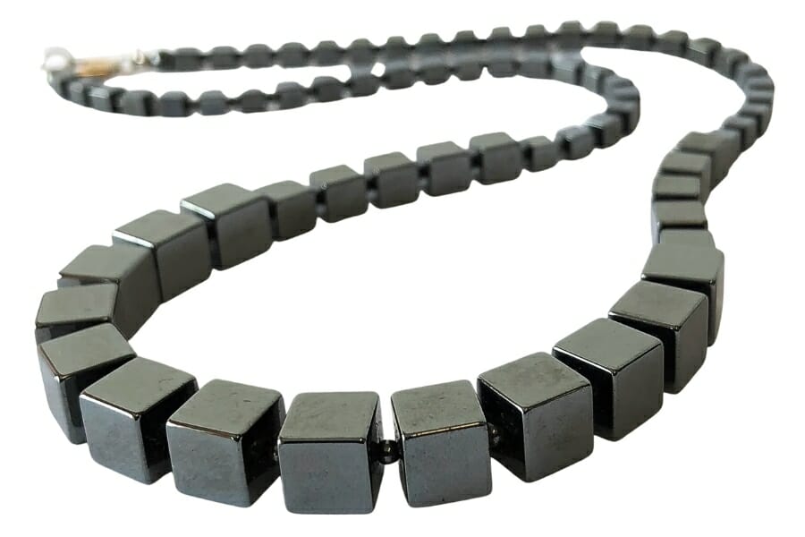 A necklace made out of gray, cubed Hematite