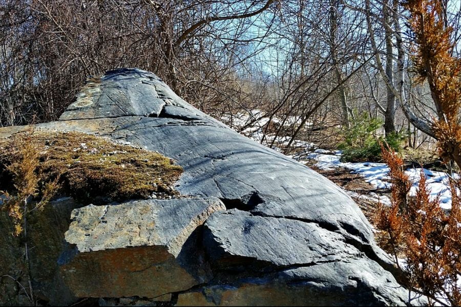 A big hill rock covered with snow at the Iron Hill Mine