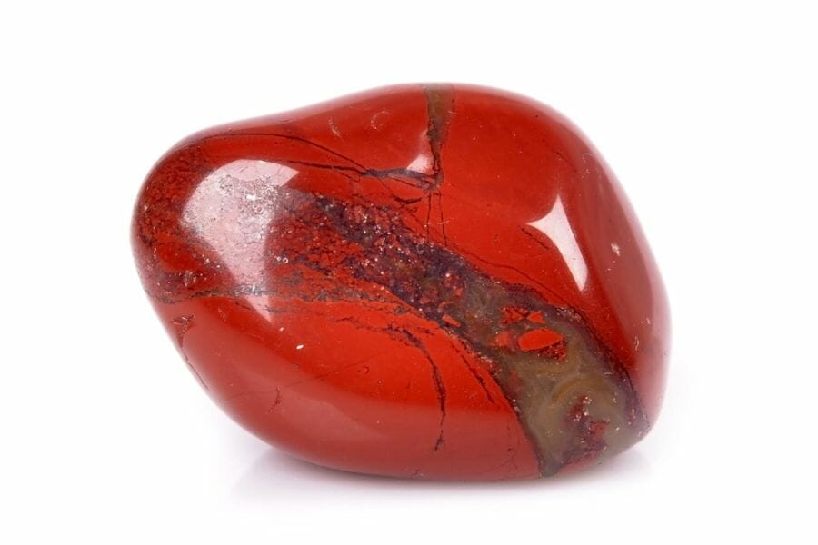 An enchanting tumbled red jasper with a smooth surface and brown streaks in the middle