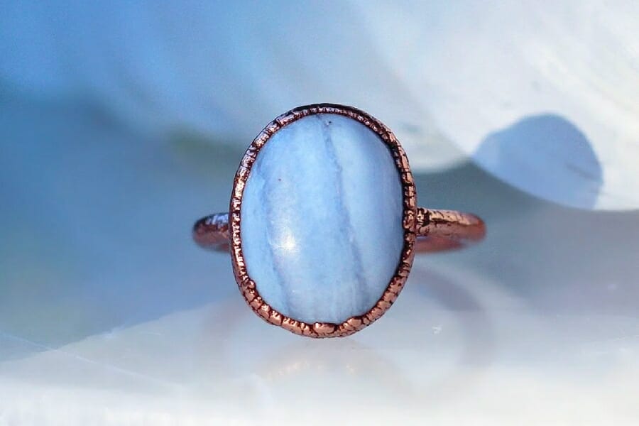 A piece of Blue Lace Agate mounted on a rose gold ring 