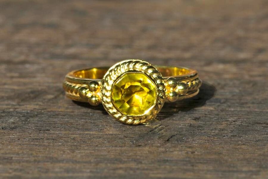 A sparkling yellow-green Mali Garnet set on a golden ring