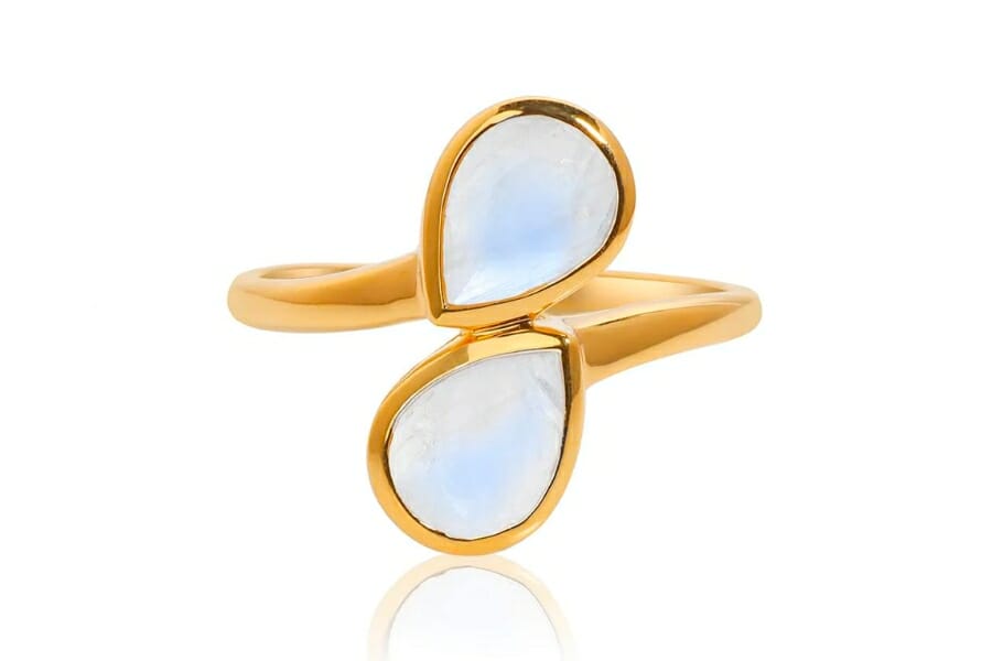 A dainty gold ring with two pieces of White Moonstones