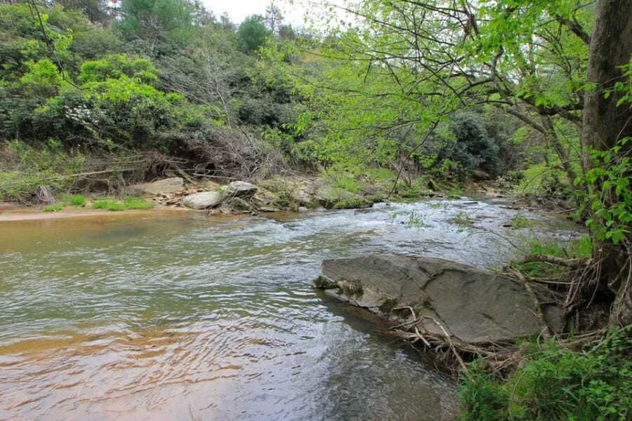 A creek and its surrounding rock formations and greeneries at the Iredell County