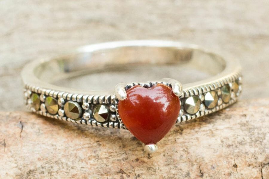 A brilliant heart-shaped red onyx ring along with crystal details