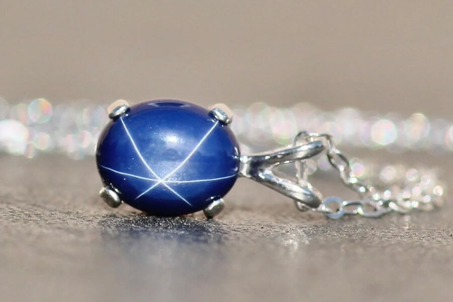 A close up view at the stunning star formation of a blue Star Sapphire pendant