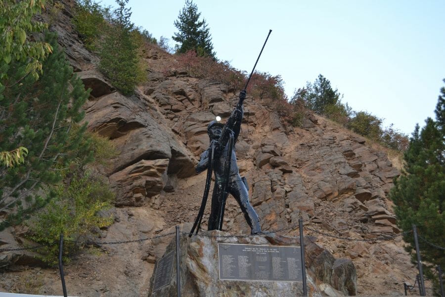 A photo of a statue marker of the Sunshine Mine