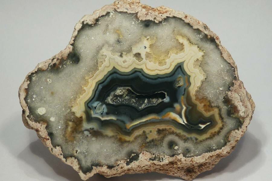 A grey, white and blue crystal-filled thunder egg