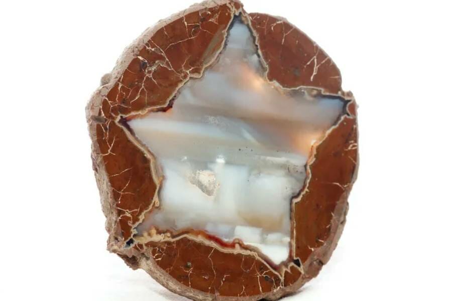 a lonestar thunder egg that is red rock and a silvery-pearl style crystal in the shape o fa star inside