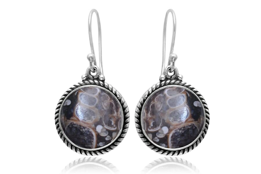 A pair of dangling earrings with round pieces of Turritella Agate