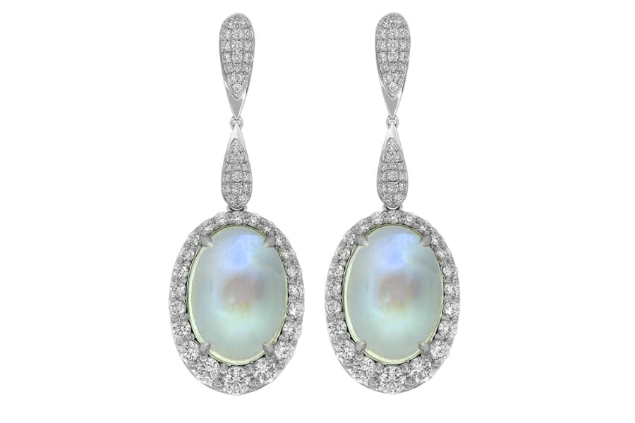 A pair of dangling earrings adorned by two White Moonstones cabochon