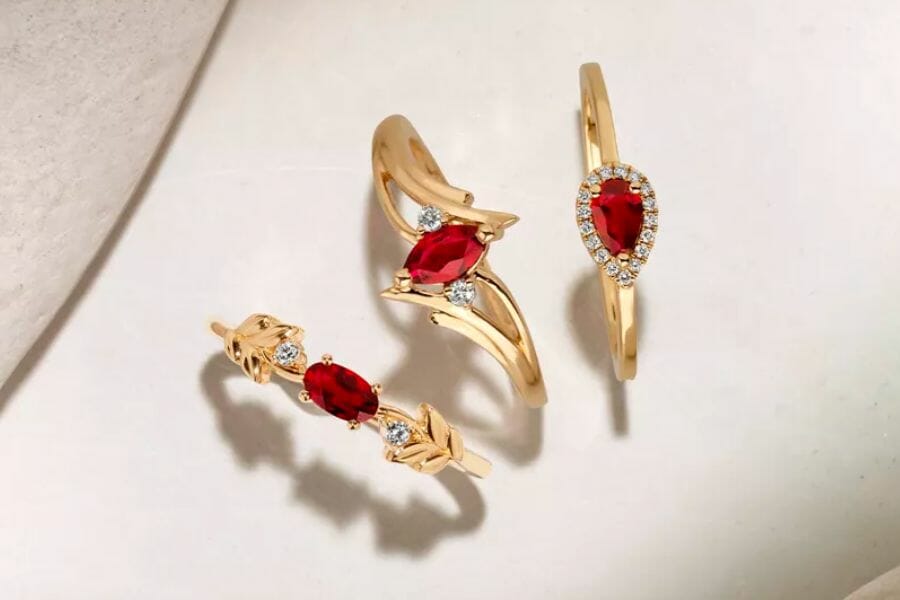 Three beautiful pieces of golden ring with sparkling red Ruby gemstones