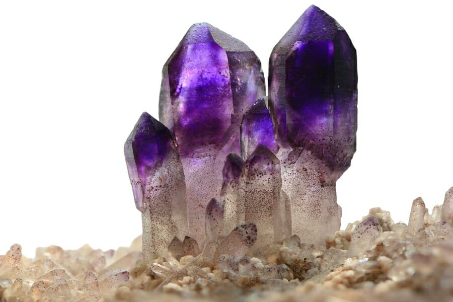Clusters of dark purple Amethyst crystals protruding